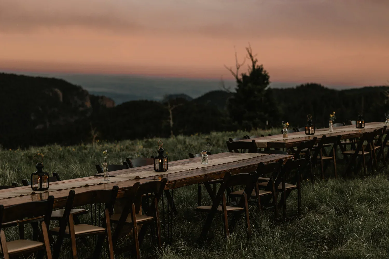 Long outdoor dinner tables overlooking the Colorado mountains at dusk